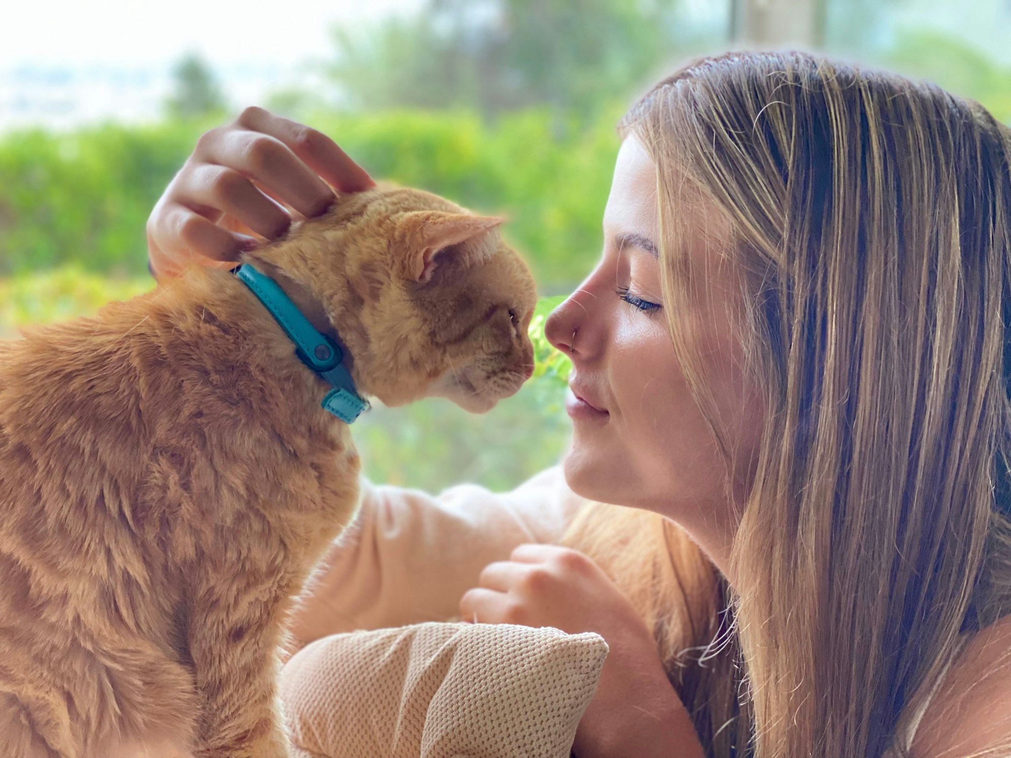 A girl and her cat share a special loving moment